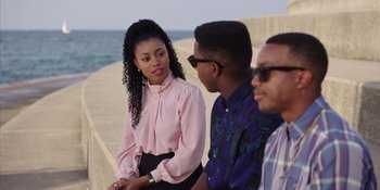 Movie still from “Heist 88” (2023), directed by Menhaj Huda – A woman sitting next to two other people; Medium shot, Over the shoulder angle