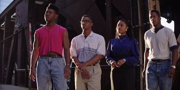 Movie still from “Heist 88” (2023), directed by Menhaj Huda – A group of young men and women standing next to each other; Medium shot, Low angle