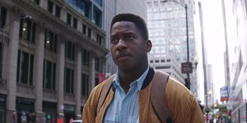 Movie still from “Heist 88” (2023), directed by Menhaj Huda – A man in a yellow jacket standing in the street; Close Up shot, Low angle