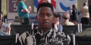 Movie still from “Heist 88” (2023), directed by Menhaj Huda – A man with a black and white patterned shirt; Close Up shot, Over the shoulder angle