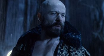 Movie still from “Hellboy” (2004), directed by Guillermo del Toro – A man with a bald head wearing a black jacket; Close Up shot, Low angle