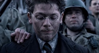 Movie still from “Hellboy” (2004), directed by Guillermo del Toro – A person wearing a suit and tie; Close Up shot, Over the shoulder angle