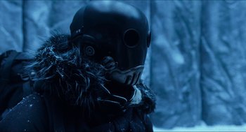 Movie still from “Hellboy” (2004), directed by Guillermo del Toro – A person wearing a black mask and a fur coat; Close Up shot, Low angle