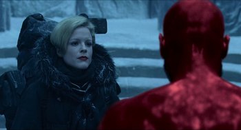 Movie still from “Hellboy” (2004), directed by Guillermo del Toro – A woman in a black jacket and a red jacket; Medium shot, Over the shoulder angle