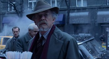 Movie still from “Hellboy” (2004), directed by Guillermo del Toro – An older man wearing a hat and a coat; Close Up shot, Over the shoulder angle