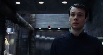 Movie still from “Hellboy” (2004), directed by Guillermo del Toro – A man standing in front of an escalator in a building; Close Up shot, Low angle