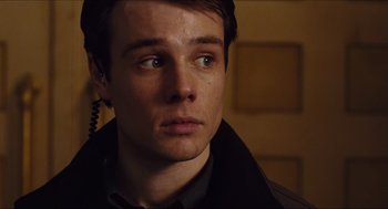 Movie still from “Hellboy” (2004), directed by Guillermo del Toro – A person wearing a jacket; Close Up shot, Low angle