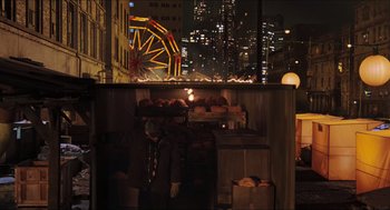Movie still from “Hellboy” (2004), directed by Guillermo del Toro – A food stand in the middle of a city at night; Wide shot, High angle