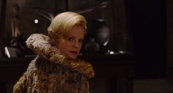 Movie still from “Hellboy” (2004), directed by Guillermo del Toro – A woman with blonde hair wearing a fur coat; Close Up shot, Low angle