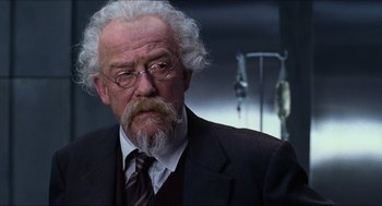 Movie still from “Hellboy” (2004), directed by Guillermo del Toro – An older man with a beard and a mustache; Close Up shot, Low angle