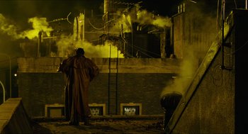 Movie still from “Hellboy” (2004), directed by Guillermo del Toro – A man standing in front of a fire hydrant at night; Wide shot, Low angle