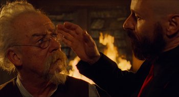 Movie still from “Hellboy” (2004), directed by Guillermo del Toro – A man with a beard and a man with a beard; Close Up shot, Over the shoulder angle