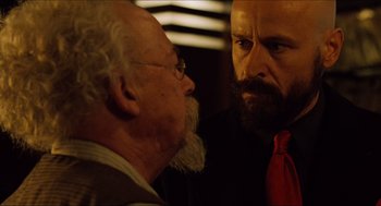 Movie still from “Hellboy” (2004), directed by Guillermo del Toro – A man with a long beard and a man with a long beard; Close Up shot, Over the shoulder angle