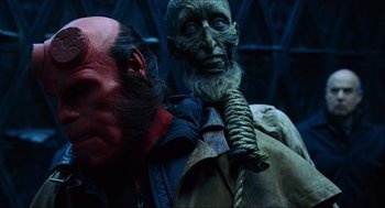 Movie still from “Hellboy” (2004), directed by Guillermo del Toro – A person with a mask on; Close Up shot, Over the shoulder angle
