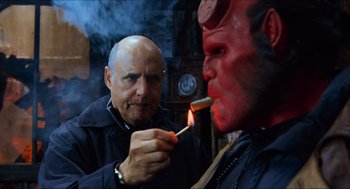 Movie still from “Hellboy” (2004), directed by Guillermo del Toro – A man lighting a match in front of a demon; Close Up shot, Over the shoulder angle