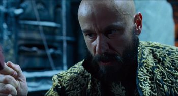 Movie still from “Hellboy” (2004), directed by Guillermo del Toro – A bald man with a beard and a mustache; Close Up shot, Low angle