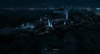 Movie still from “Hellboy II: The Golden Army” (2008), directed by Guillermo del Toro – An aerial view of a large building at night; Extreme Wide shot, High angle