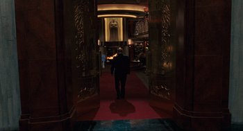 Movie still from “Hellboy II: The Golden Army” (2008), directed by Guillermo del Toro – A man walking through a hallway in a building; Wide shot, Over the shoulder angle