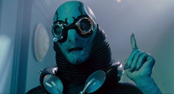 Movie still from “Hellboy II: The Golden Army” (2008), directed by Guillermo del Toro – A man in a blue suit and goggles; Close Up shot, Over the shoulder angle