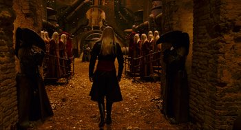Movie still from “Hellboy II: The Golden Army” (2008), directed by Guillermo del Toro – A group of people standing in a room; Wide shot, Over the shoulder angle