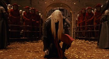Movie still from “Hellboy II: The Golden Army” (2008), directed by Guillermo del Toro – A woman kneeling down in the middle of a field; Wide shot, Over the shoulder angle