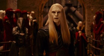 Movie still from “Hellboy II: The Golden Army” (2008), directed by Guillermo del Toro – A man with long blonde hair and a white face; Medium shot, Over the shoulder angle