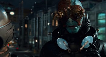 Movie still from “Hellboy II: The Golden Army” (2008), directed by Guillermo del Toro – A man in a blue suit with a mask on his face; Close Up shot, Over the shoulder angle