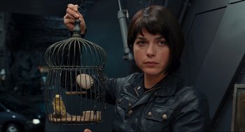 Movie still from “Hellboy II: The Golden Army” (2008), directed by Guillermo del Toro – A woman holding a bird in a bird cage; Close Up shot, Low angle