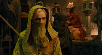Movie still from “Hellboy II: The Golden Army” (2008), directed by Guillermo del Toro – A woman in a yellow robe and a man in a black robe; Medium shot, Over the shoulder angle