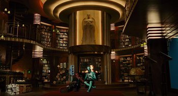 Movie still from “Hellboy II: The Golden Army” (2008), directed by Guillermo del Toro – A person sitting in front of a fireplace in a library; Wide shot, Low angle