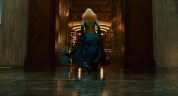 Movie still from “Hellboy II: The Golden Army” (2008), directed by Guillermo del Toro – A woman with long blonde hair is walking down a hall way; Wide shot, Low angle