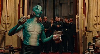 Movie still from “Hellboy II: The Golden Army” (2008), directed by Guillermo del Toro – A man that is painted like an alien; Medium shot, Over the shoulder angle