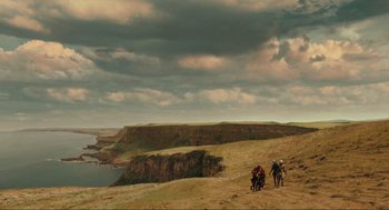 Movie still from “Hellboy II: The Golden Army” (2008), directed by Guillermo del Toro – A group of people riding horses on top of a hill; Extreme Wide shot, Low angle