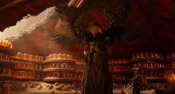 Movie still from “Hellboy II: The Golden Army” (2008), directed by Guillermo del Toro – An image of an angel in a room full of candles; Wide shot, Low angle