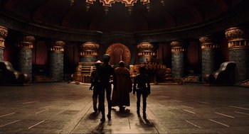 Movie still from “Hellboy II: The Golden Army” (2008), directed by Guillermo del Toro – A group of people standing in front of an elaborate structure; Wide shot, Low angle