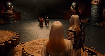 Movie still from “Hellboy II: The Golden Army” (2008), directed by Guillermo del Toro – A group of people standing in a circle on a stage; Wide shot, High angle