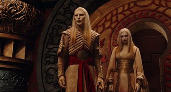 Movie still from “Hellboy II: The Golden Army” (2008), directed by Guillermo del Toro – A couple of people standing next to each other; Medium shot, Low angle