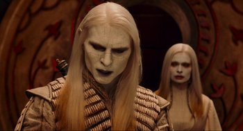 Movie still from “Hellboy II: The Golden Army” (2008), directed by Guillermo del Toro – Two people with long blonde hair and white makeup; Close Up shot, Over the shoulder angle