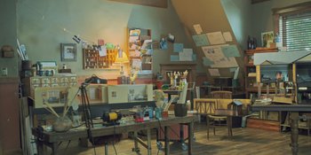 Movie still from “Hereditary” (2018), directed by Ari Aster – A room with a lot of papers on the wall; Wide shot, High angle