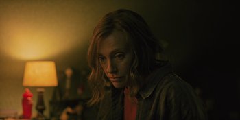 Movie still from “Hereditary” (2018), directed by Ari Aster – A woman with long blonde hair stares into the camera; Close Up shot, Low angle