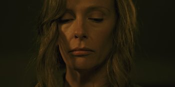 Movie still from “Hereditary” (2018), directed by Ari Aster – A person with her eyes closed; Close Up shot, Low angle
