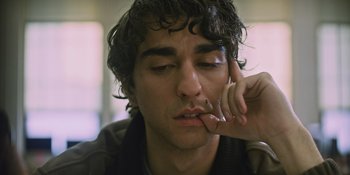 Movie still from “Hereditary” (2018), directed by Ari Aster – A person with curly hair; Close Up shot, Low angle