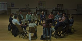 Movie still from “Hereditary” (2018), directed by Ari Aster – A group of people sitting in chairs in a circle; Wide shot, High angle