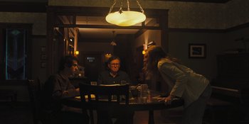 Movie still from “Hereditary” (2018), directed by Ari Aster – A group of people sitting at a table in a restaurant; Medium shot, Over the shoulder angle