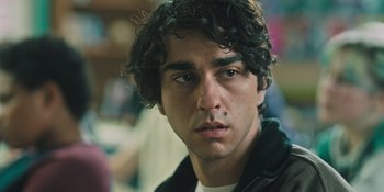 Movie still from “Hereditary” (2018), directed by Ari Aster – A person wearing a jacket; Close Up shot, Over the shoulder angle