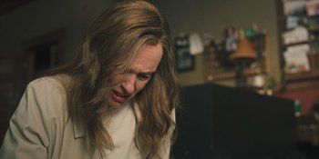 Movie still from “Hereditary” (2018), directed by Ari Aster – A person with long brown hair; Close Up shot, High angle