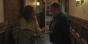 Movie still from “Hereditary” (2018), directed by Ari Aster – A man and a woman looking at a book; Medium shot, High angle