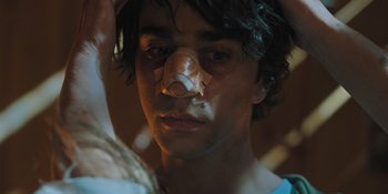 Movie still from “Hereditary” (2018), directed by Ari Aster – A person with a nose ring; Close Up shot, High angle