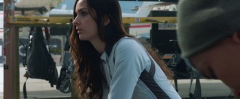 Movie still from “Hex” (2022), directed by Chris Johnston – A woman with long brown hair looking to her left; Close Up shot, Low angle