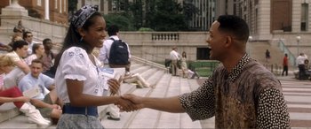 Movie still from “Hitch” (2005), directed by Andy Tennant – A man and a woman shaking hands on steps; Medium shot, Over the shoulder angle